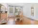 Bright dining area featuring wood floors, a round table with seating, and a charming chandelier at 203 Belmont Park Dr, Canton, GA 30115