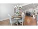 Bright dining room featuring wood floors, a round table with seating, and views of the gourmet kitchen at 203 Belmont Park Dr, Canton, GA 30115