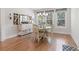 Bright dining area featuring wood floors, a round table with seating, and a charming chandelier at 203 Belmont Park Dr, Canton, GA 30115