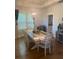 Charming dining area with a modern chandelier and ample natural light from shuttered windows at 203 Belmont Park Dr, Canton, GA 30115