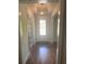 Inviting foyer with hardwood floors, a decorative light fixture, and a front door with a window at 203 Belmont Park Dr, Canton, GA 30115