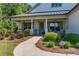 Charming home with a covered porch and beautifully landscaped front yard at 203 Belmont Park Dr, Canton, GA 30115