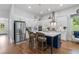 Gourmet kitchen boasts a large island, stainless appliances, and white cabinets at 203 Belmont Park Dr, Canton, GA 30115