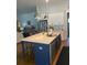 Spacious kitchen featuring a center island with a sink, stainless steel appliances and pendant lighting at 203 Belmont Park Dr, Canton, GA 30115