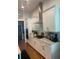 Modern kitchen with white cabinets, stainless steel appliances, and a sleek vent hood at 203 Belmont Park Dr, Canton, GA 30115