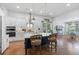 Open-concept kitchen showcasing a large center island, white cabinetry, and modern stainless steel appliances at 203 Belmont Park Dr, Canton, GA 30115