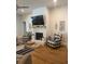 Cozy living room featuring a brick fireplace, TV and comfortable armchairs with accent pillows at 203 Belmont Park Dr, Canton, GA 30115