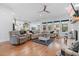Bright, open living room with hardwood floors, comfortable seating, and a ceiling fan at 203 Belmont Park Dr, Canton, GA 30115