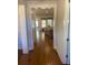 Open-concept living room with hardwood floors and abundant natural light from two windows at 203 Belmont Park Dr, Canton, GA 30115