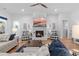 Comfortable living room with a fireplace, a ceiling fan, and an open floor plan at 203 Belmont Park Dr, Canton, GA 30115