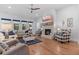Comfortable living room featuring wood floors, a fireplace, and lots of natural light at 203 Belmont Park Dr, Canton, GA 30115