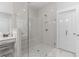 Bright bathroom with frameless shower, marble floors and a vanity area at 203 Belmont Park Dr, Canton, GA 30115