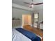 This is a large main bedroom with hard wood floors and a fan at 203 Belmont Park Dr, Canton, GA 30115
