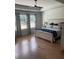 Inviting main bedroom with hardwood floors, tray ceiling, and large windows at 203 Belmont Park Dr, Canton, GA 30115