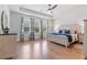 Spacious primary bedroom with hardwood floors, natural light, and tray ceiling at 203 Belmont Park Dr, Canton, GA 30115