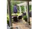 Covered patio with a dining table, outdoor seating, and green foliage at 203 Belmont Park Dr, Canton, GA 30115