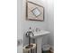 Stylish powder room with pedestal sink, designer mirror, and modern decor at 203 Belmont Park Dr, Canton, GA 30115
