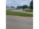 View of a neighborhood street with lush green landscaping and a new home community at 203 Belmont Park Dr, Canton, GA 30115