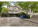 Expansive backyard featuring a brick patio, multilevel deck, and lush landscaping, perfect for entertaining at 241 Nacoochee Nw Dr, Atlanta, GA 30305