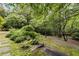 Picturesque backyard with stone path, verdant trees, and manicured landscaping at 241 Nacoochee Nw Dr, Atlanta, GA 30305