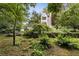 Lush landscaping and stone walls create a serene backyard oasis with a charming garden at 241 Nacoochee Nw Dr, Atlanta, GA 30305