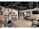 Finished basement with exposed ceiling, painted brick, and open play area at 241 Nacoochee Nw Dr, Atlanta, GA 30305