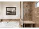 Elegant bathroom featuring a soaking tub, shower, and marble countertops at 241 Nacoochee Nw Dr, Atlanta, GA 30305