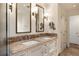 Elegant bathroom featuring double sinks, granite countertop and custom cabinetry at 241 Nacoochee Nw Dr, Atlanta, GA 30305