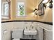 Charming powder room with classic black and white tile at 241 Nacoochee Nw Dr, Atlanta, GA 30305
