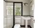 Classic bathroom with a pedestal sink, tiled shower, and natural light at 241 Nacoochee Nw Dr, Atlanta, GA 30305
