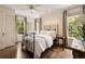 Cozy bedroom with large windows offering abundant natural light and a ceiling fan at 241 Nacoochee Nw Dr, Atlanta, GA 30305