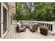 Large deck with outdoor seating and views of the lush backyard at 241 Nacoochee Nw Dr, Atlanta, GA 30305