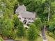 Aerial view of a traditionally styled home with a gray roof, solar panels, and mature landscaping at 241 Nacoochee Nw Dr, Atlanta, GA 30305