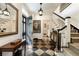 Elegant foyer with black and white checkered floor, open staircase, and stylish decor at 241 Nacoochee Nw Dr, Atlanta, GA 30305