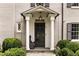 Inviting front entrance with classic columns and covered porch, and meticulous landscaping at 241 Nacoochee Nw Dr, Atlanta, GA 30305