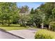 Charming front yard with a long driveway, mature trees, and neatly manicured landscaping at 241 Nacoochee Nw Dr, Atlanta, GA 30305