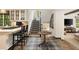Open-concept kitchen with bar seating, a staircase, and modern appliances at 241 Nacoochee Nw Dr, Atlanta, GA 30305