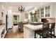 Open kitchen layout with hardwood floors and island with seating at 241 Nacoochee Nw Dr, Atlanta, GA 30305