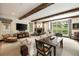 Bright living room with fireplace, wood beams and large windows at 241 Nacoochee Nw Dr, Atlanta, GA 30305