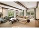 Spacious living room with fireplace, beams and large windows for natural light at 241 Nacoochee Nw Dr, Atlanta, GA 30305