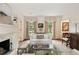 Comfortable living area with fireplace, neutral furniture, and French door access at 241 Nacoochee Nw Dr, Atlanta, GA 30305