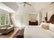 Spacious main bedroom featuring vaulted ceilings and a charming seating area at 241 Nacoochee Nw Dr, Atlanta, GA 30305