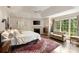 Bright main bedroom boasts a decorative rug, seating area and fireplace at 241 Nacoochee Nw Dr, Atlanta, GA 30305