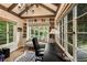 Sunlit home office with built-in shelves, hardwood floors, and views of the landscape at 241 Nacoochee Nw Dr, Atlanta, GA 30305