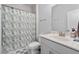 Bathroom featuring shower with curtain, white vanity and neutral tile flooring at 361 Watson Ave, Woodstock, GA 30189