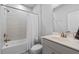 White bathroom with shower over tub and sink with chrome faucet at 361 Watson Ave, Woodstock, GA 30189