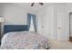 Bedroom features ceiling fan, neutral carpet, and walk-in closet at 361 Watson Ave, Woodstock, GA 30189