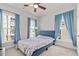 Bright bedroom with large windows and modern blue curtains at 361 Watson Ave, Woodstock, GA 30189