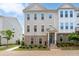 Charming townhouse featuring a brick facade, inviting entrance, and meticulously manicured landscaping at 361 Watson Ave, Woodstock, GA 30189