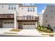 Back exterior of modern townhomes, featuring private garages and balconies at 361 Watson Ave, Woodstock, GA 30189